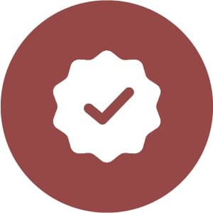 A white checkmark inside a scalloped circle on a red circular background.